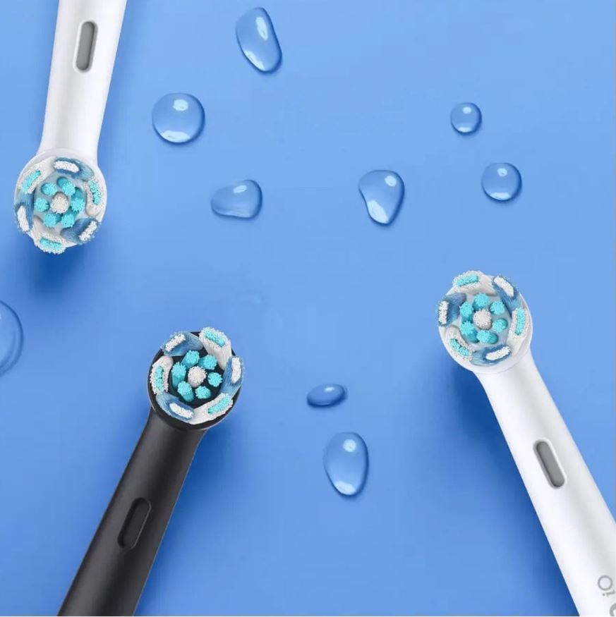 Oral-B iO 6 Black Lava opzetborstels close-up met waterdruppels op blauwe achtergrond