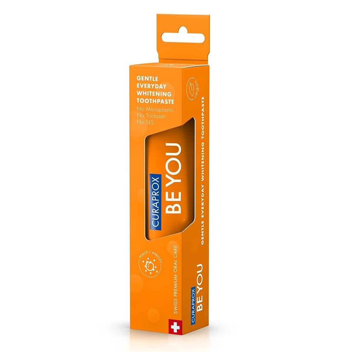 Curaprox BE YOU tandpasta perzik/abrikoos verpakking in oranje doosje schuin van voren