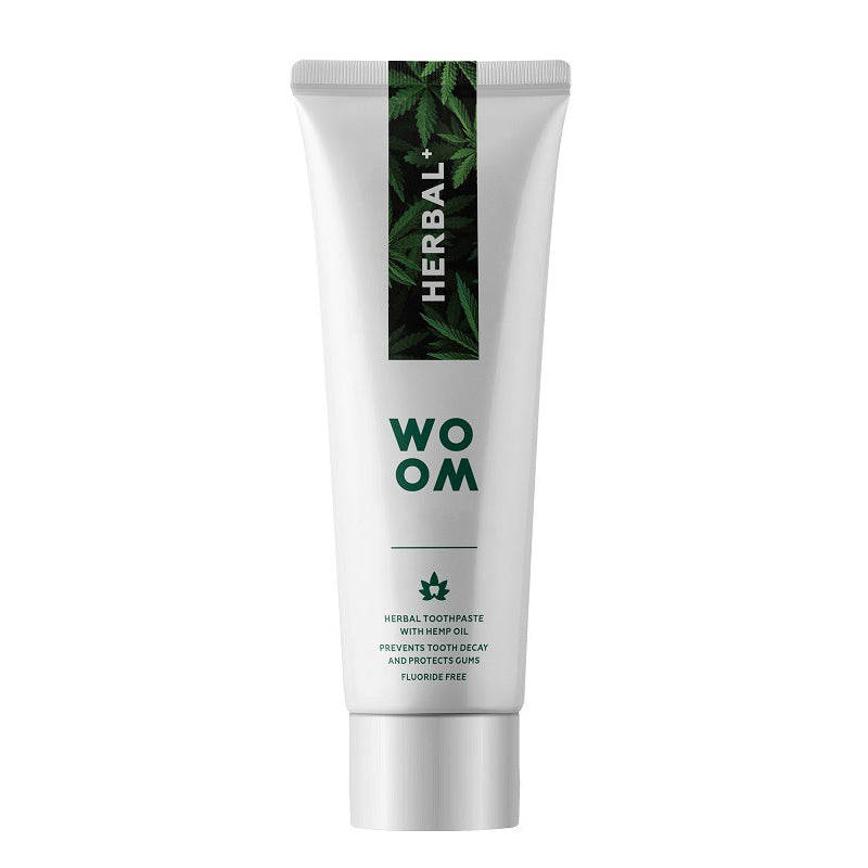 Woom Herbal+ tandpasta tube met tekst over kruidenformule en fluoridevrij